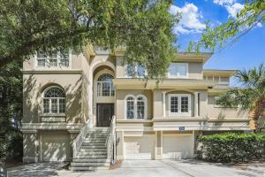 a large house with stairs in front of it at 4 Surfwatch Way- Pet Friendly, Pool & Spa, Short Walk To Beach! FREE Activities Included in Hilton Head Island