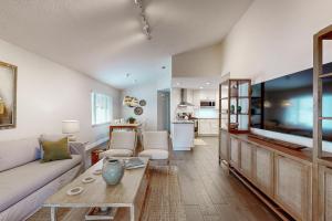 a living room with a large flat screen tv at Bayside Bungalow in Tampa