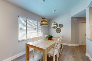 a dining room with a wooden table and chairs at Bayside Bungalow in Tampa +17 photos
