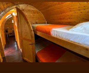 a bedroom with two bunk beds in a cabin at Refugio Piedra Parada in Tona
