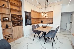 a kitchen with a wooden table and chairs at AGIA- luxury apartment Sofia in Sofia