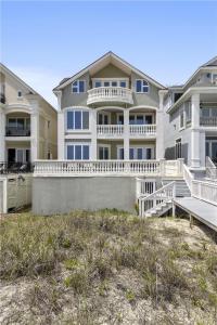 a large apartment building with white balconies on the beach at 6 Collier Beach Road- Oceanfront, Large Pool, Elevator, FREE Activities Included in Hilton Head Island