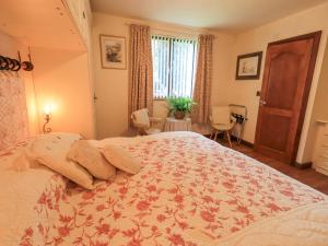 En eller flere senge i et værelse på Stonegarth Cottage