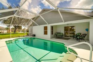 a swimming pool with a pergola and a house at 4 Mi to Beach Beach Haven with Water Views! in Fort Myers