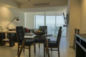 a dining room with a table and chairs with a view at Exquisite Oceanfront Condo outstanding experience! in Puerto Vallarta