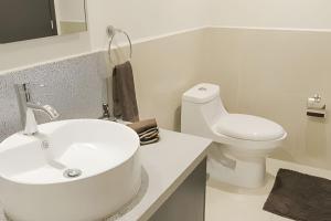 a white bathroom with a sink and a toilet at Exquisite Oceanfront Condo outstanding experience! in Puerto Vallarta +15 photos