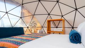 a room with a bed in a triangular wall at La Cabaña Glamping Geronimo in Playa Blanca