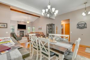 a dining room and living room with a table and chairs at Near Dtwn Eureka Springs Holiday Island Home! in Holiday Island
