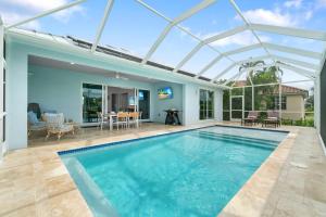 a swimming pool in a house with a glass roof at Deja Blu in Marco Island