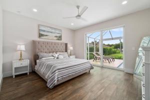 a bedroom with a bed and a sliding glass door at Deja Blu in Marco Island