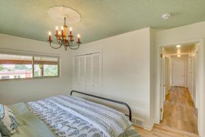 a bedroom with a bed and a chandelier at Walk to Downtown Brigham City Family Home in Brigham City