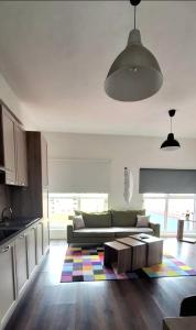 a living room with a couch and a table at Modern Mountain View P&E Tirana Apartment Netflix included in Tirana