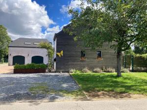 a barn with a tree in front of it at Le Papillon d'Or in Arlon