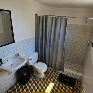 a bathroom with a toilet and a sink and a shower at Habitación Matrimonial en el Centro in Tacna
