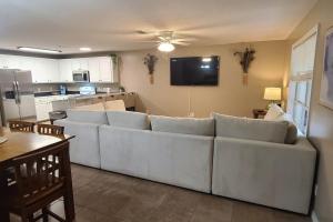 a living room with a white couch and a kitchen at EastGate 11B in Hammond