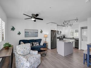 a living room with a blue couch and a kitchen at Best Catch on Grouper LN at Ocean Isles in Marathon