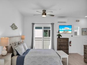 a bedroom with a bed and a ceiling fan at Best Catch on Grouper LN at Ocean Isles in Marathon +31 photos