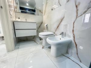 Un baño blanco con inodoro y lavabo. en Blessing room 4, en Nápoles