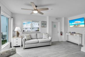a living room with a couch and a ceiling fan at Ocean Isles Seaside Oasis in Marathon