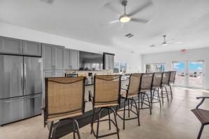 a kitchen with a row of chairs and a bar at Ocean Isles Seaside Oasis in Marathon