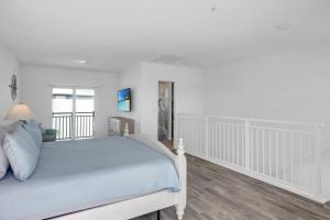 a white bedroom with a bed and a window at Gated Oceanfront Heated Pool in Marathon +21 photos