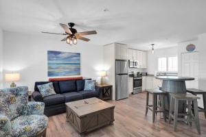 a living room with a couch and a kitchen at Ocean Isles Rustic Inn in Marathon