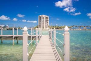 a wooden pier with a building in the water at Oceans Edge Retreat in Key Colony Beach