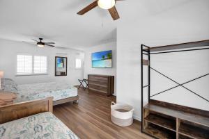 a bedroom with two beds and a ceiling fan at Ocean Isles Rustic Inn in Marathon +35 photos