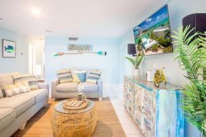 a living room with a couch and a table at Oceans Edge Retreat in Key Colony Beach