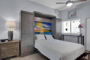 a bedroom with a bed and a painting on the wall at Oceanside Spacious Studio Escape in Marathon +17 photos