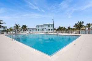 a large swimming pool with blue water at Oceanside Spacious Studio Escape in Marathon