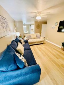 a large blue couch in a living room with at Eastgate 14B Stylish Townhouse 5 min to downtown Hammond in Hammond