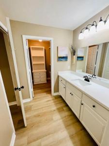 a bathroom with a sink and a large mirror at Eastgate 14B Stylish Townhouse 5 min to downtown Hammond in Hammond +60 photos
