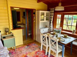 a kitchen and dining room with a table and chairs at Szivike Vendégház in Ábrahámhegy +23 photos