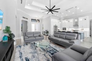a living room with two couches and a kitchen at Gulf Breezes in Marco Island