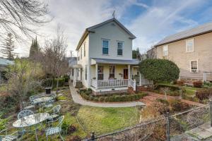 a white house with a yard with tables and chairs at Timeless Victorian Gem w Breathtaking Mountains in Sutter Creek