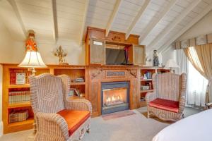 a living room with two chairs and a fireplace at Timeless Victorian Gem w Breathtaking Mountains in Sutter Creek