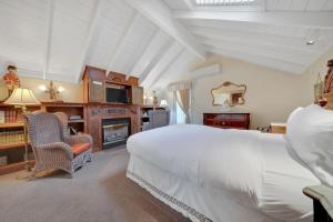 a bedroom with a large bed and a fireplace at Timeless Victorian Gem w Breathtaking Mountains in Sutter Creek