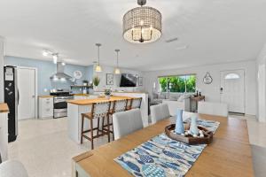 a kitchen and living room with a table and a kitchen and a dining room at Sandcastle Harbor Pool and FirePit in Port Orange