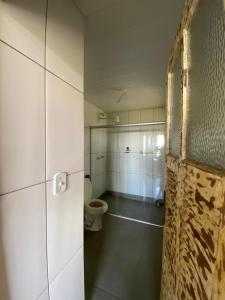 a bathroom with a toilet in a room at Chalés Lavras de Minas - Brasil in Lavras Novas