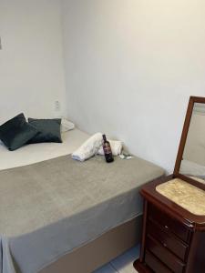 a bedroom with a bed with a bottle on it at Pousada Aloha Santos in Santos +94 photos