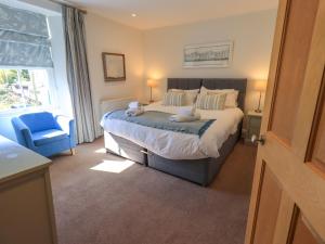 a bedroom with a bed with two stuffed animals on it at Stones Throw Cottage in Ambleside