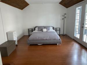 a bedroom with a bed and a wooden floor at Relaxing 3 bed 2 bath home by the intracoastal in Daytona Beach
