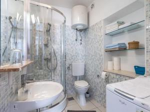 a bathroom with a shower and a toilet and a sink at Apartments Sonja - Two Bedroom Apartment with Balcony and Garden View A3 2 ST in Pučišća