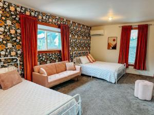 a living room with two beds and a couch at Old World Charm River Views in Lewiston