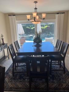 a dining room with a blue table and chairs at SurfCity Villa Chateau Relaxeau in Huntington Beach +4 photos