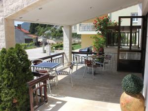 a patio with a table and chairs and a table and chairsktop at Guest House San Antonio-Comfort One Bedroom Apartment with Balcony no 1 in Ploče
