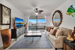 a living room with a couch and a table at Completely Remodeled 2BD-2BA Plaza Bonita in Cabo San Lucas