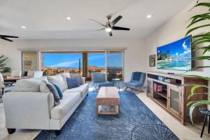 a living room with a couch and a tv at 2BD-2BA Condo at Ventanas 3B in Cabo San Lucas
