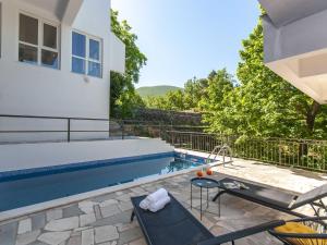a villa with a swimming pool and a house at Villa Green Castle - Five bedroom villa with swimming pool in Zadvarje